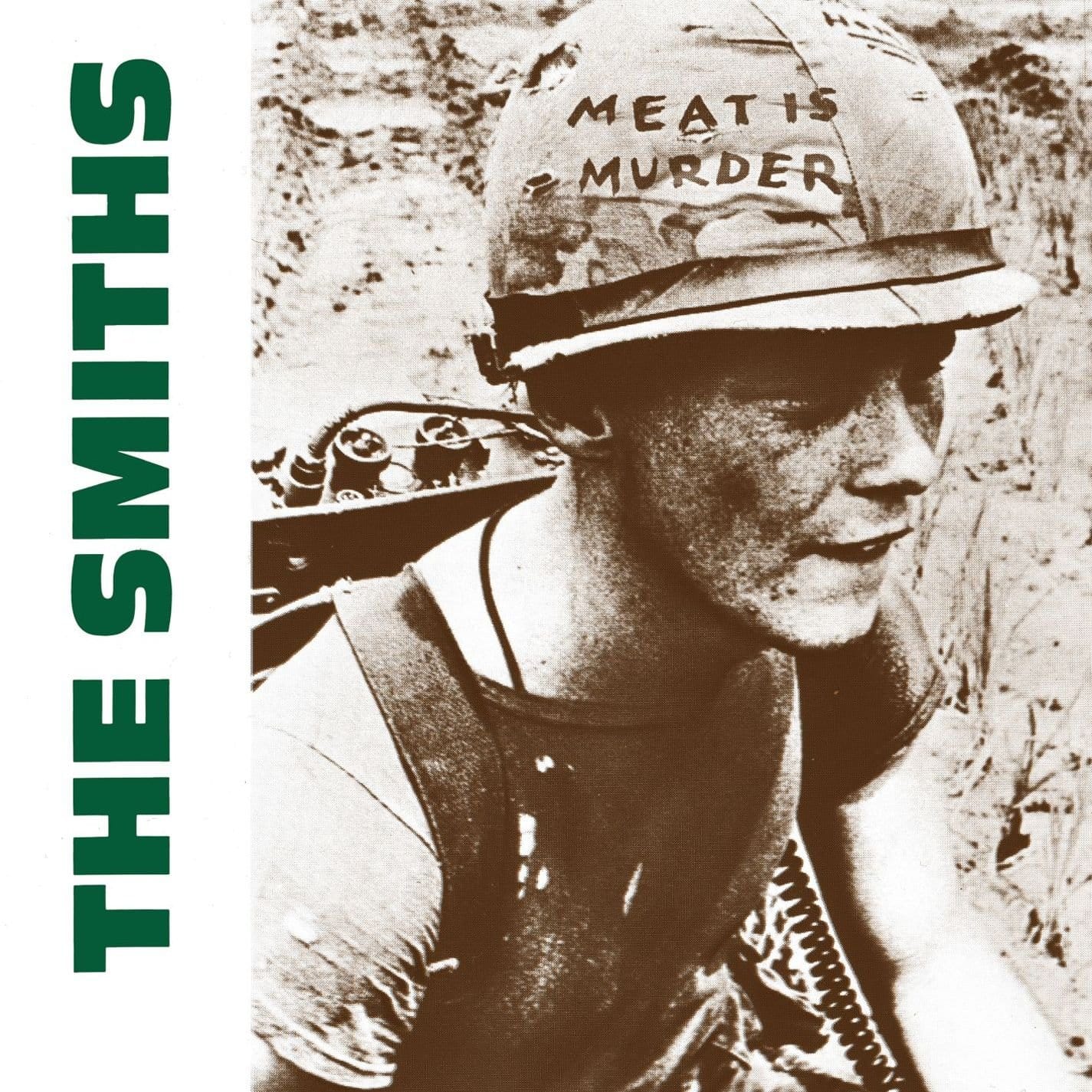 The Smiths Meat Is Murder album cover, showing a close-up black-and-white photograph of a young man eating a piece of meat, with bold white text displaying the band name and album title